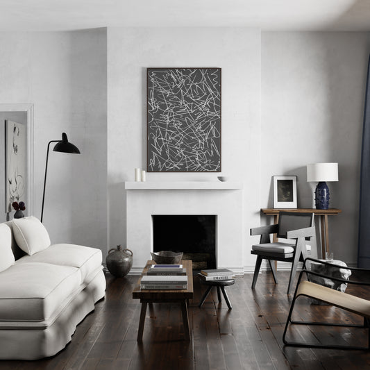 Black and white abstract art print in a cozy living room.