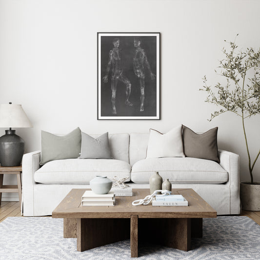 Black and white anatomy art print depicting the human body in a cozy interior.