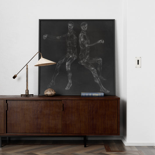 Black and white anatomy art print with two seated figures in a minimalist space.