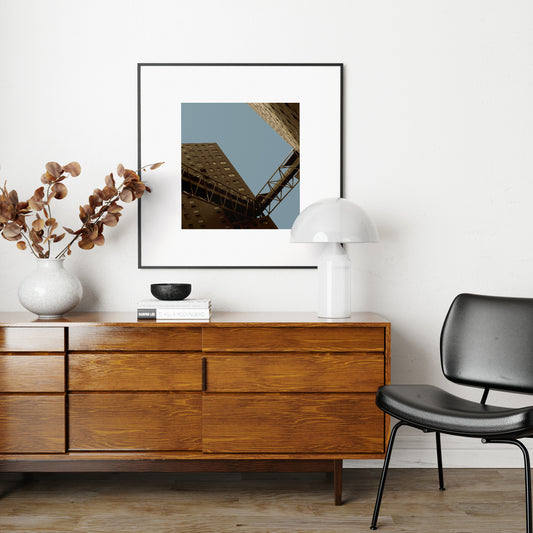 Urban photography print above a wood sideboard.