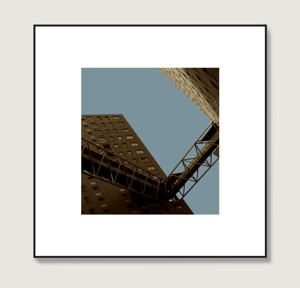 Urban photography art print with apartment blocks in perspective on a flat blue sky.