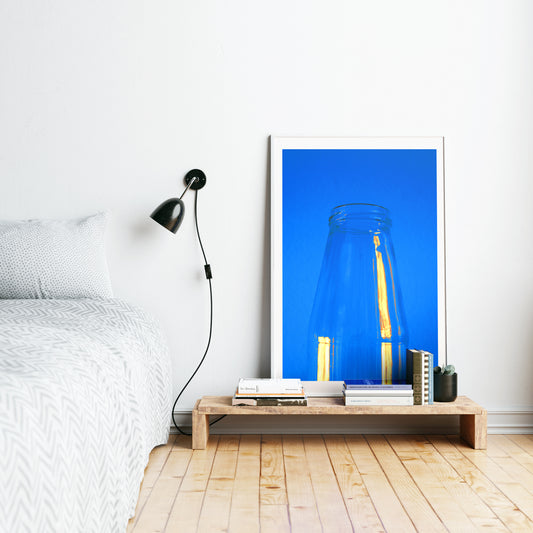 Minimalist blue art print in a bedroom.