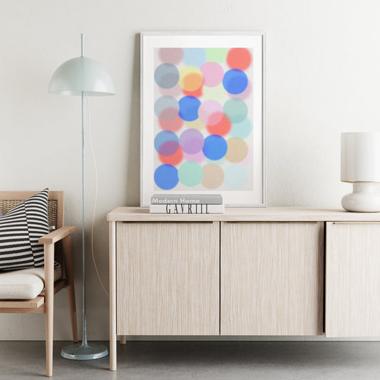 Modern interior with a wooden sideboard, colorful abstract art, and a chair with striped cushions.