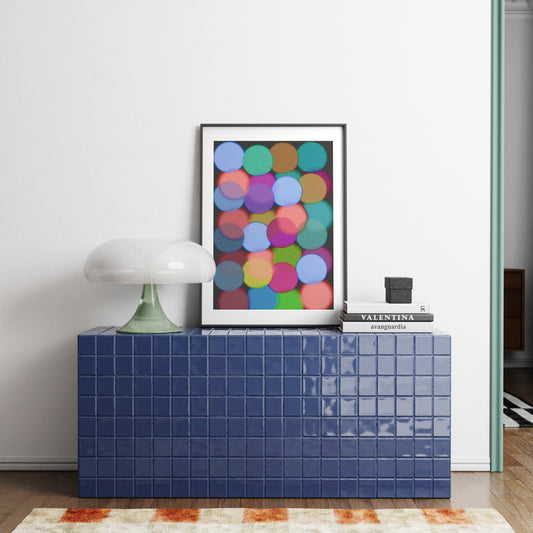Blue tiled cabinet with a colorful abstract art print on a white wall.