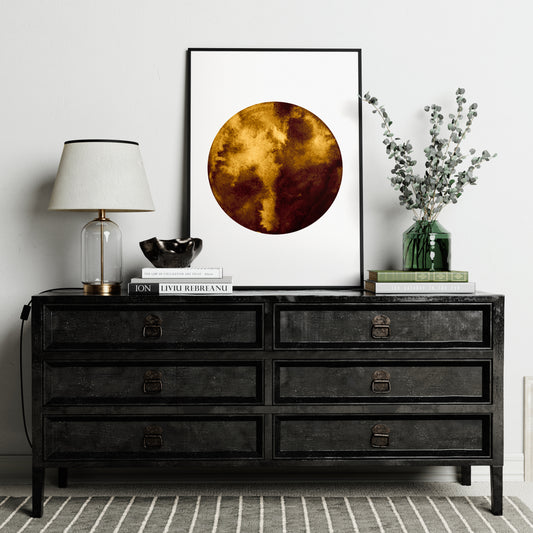 Planet minimalist graphic art print on a black sideboard.