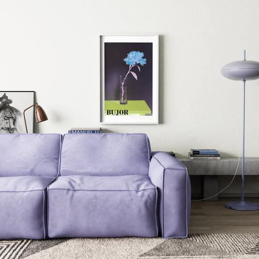 Modern living room with a purple sofa, framed artwork, and decorative items.