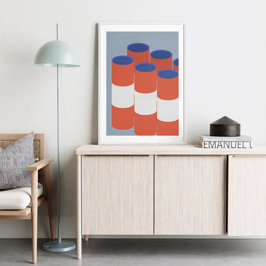 Red and blue graphic art print in a natural, bright interior.