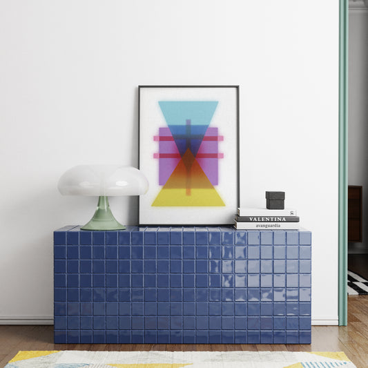 Modern interior with a blue tiled console table, colorful abstract art, and decorative items.