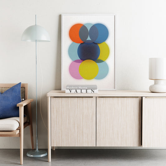 Modern living room with a wooden sideboard, colorful abstract art, and a chair.