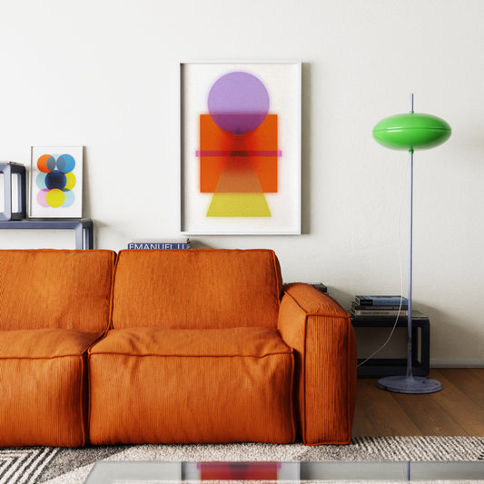 Orange sofa in a living room with abstract art and a green lamp.