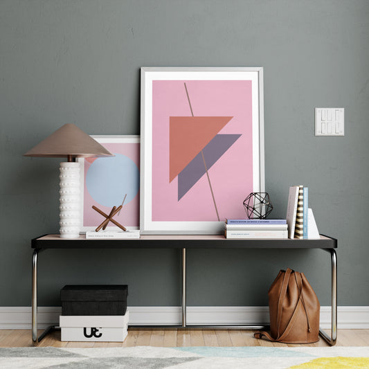 Two pink abstract graphic art prints in a modern interior.