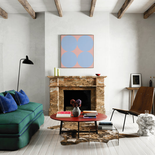 Contemporary minimalist art print with blue circles on pink, in a large farmhouse living room.