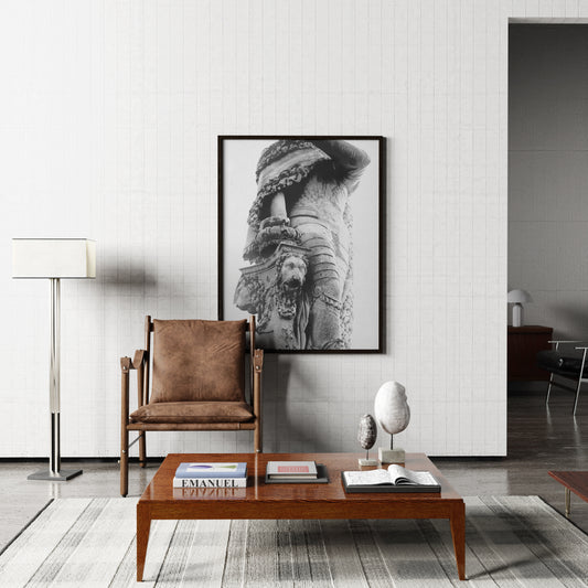 Modern living room with a brown chair, wooden coffee table, and framed artwork on the wall.