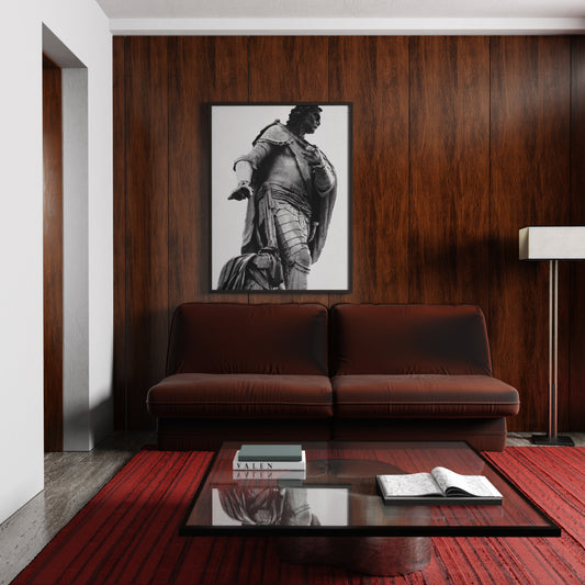 Modern living room with a brown sofa, wooden coffee table, and framed artwork on a wooden wall.