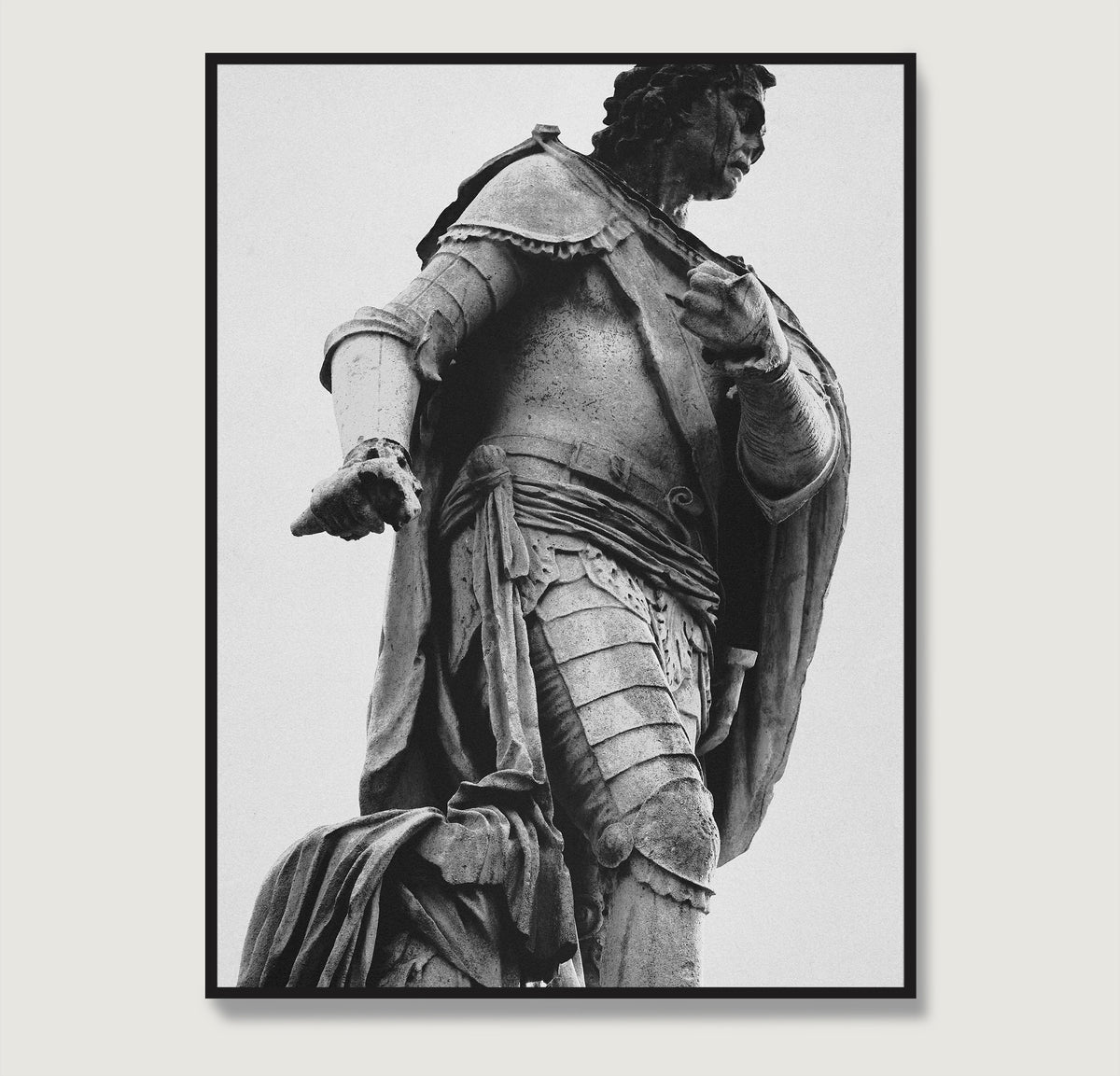 Framed black and white photography art print with a statue of a historical figure in armor against a light gray background.