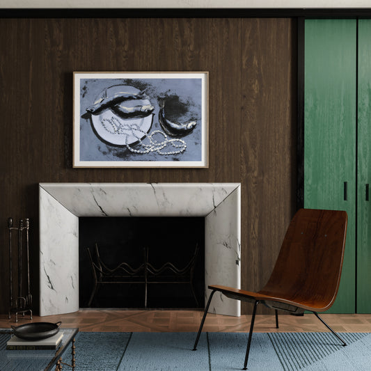 Modern living room with marble fireplace, wooden chair, and framed art print with fish and pearls on wall.