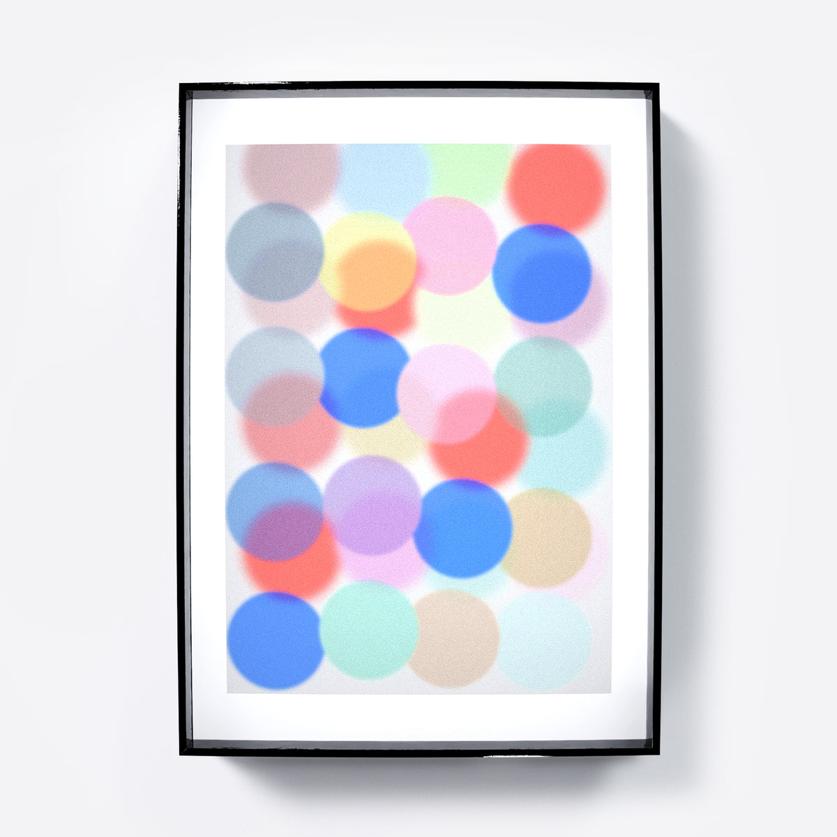 Framed artwork with colorful dots on a light background