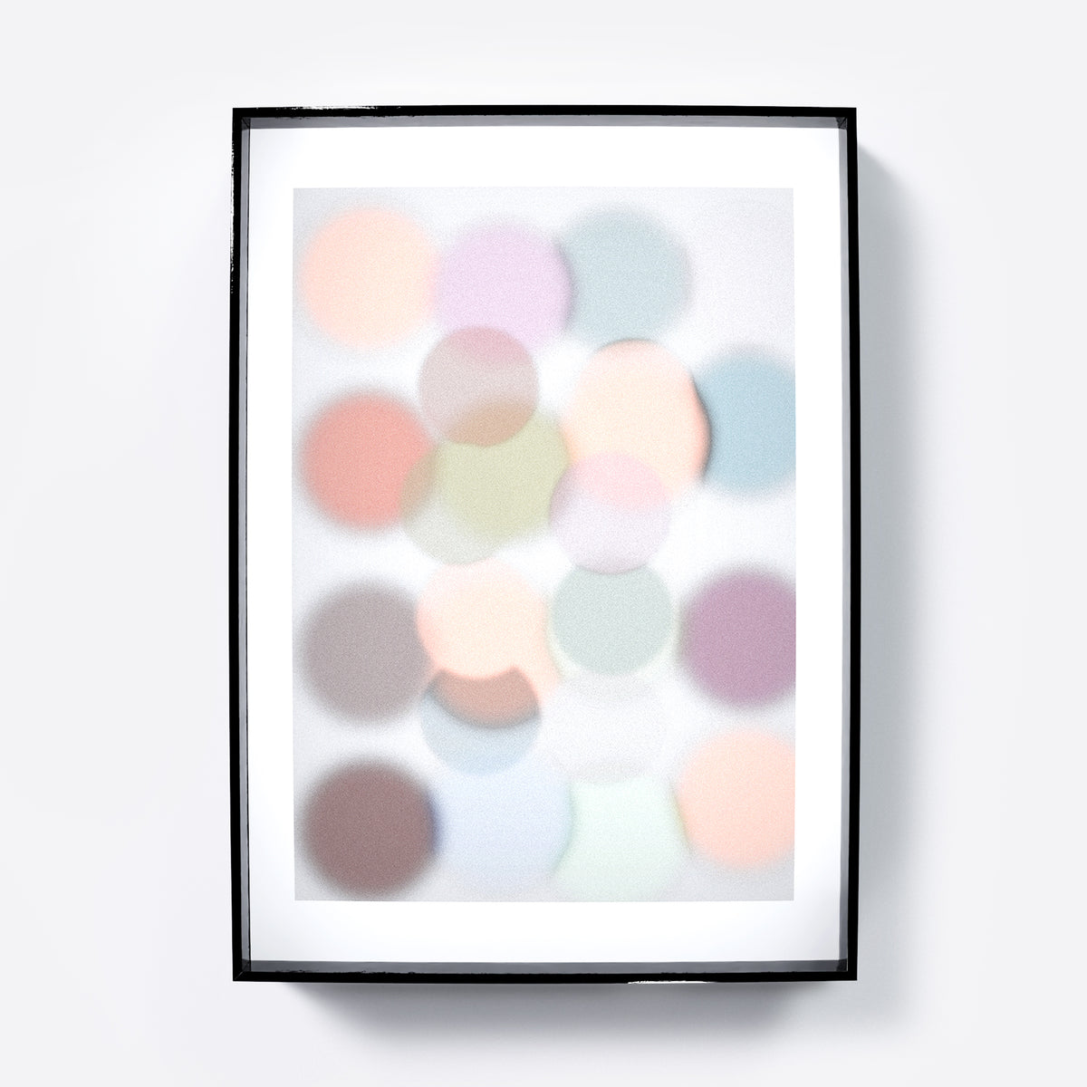 Framed abstract art print with pastel-colored circles on a light gray background.