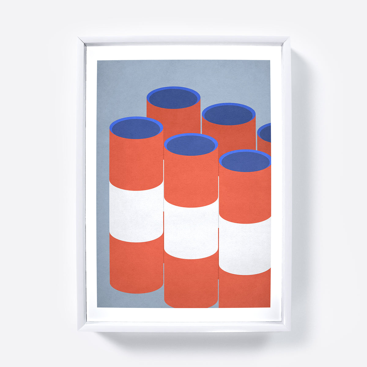 Framed artwork of red and blue cylindrical shapes on a light blue background