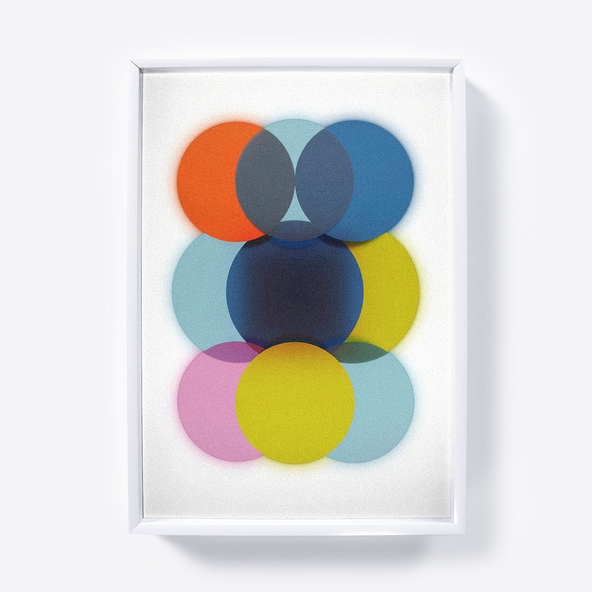 Framed abstract art print with colorful circles on a light gray background.