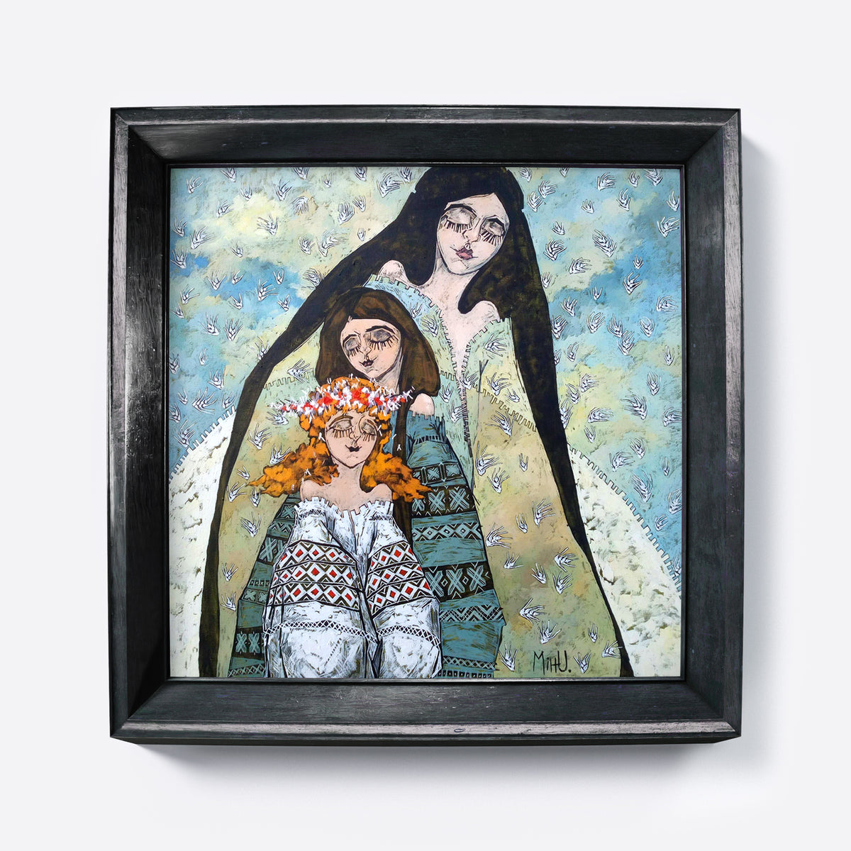 Framed artwork of a woman and two children with a black frame on a white background