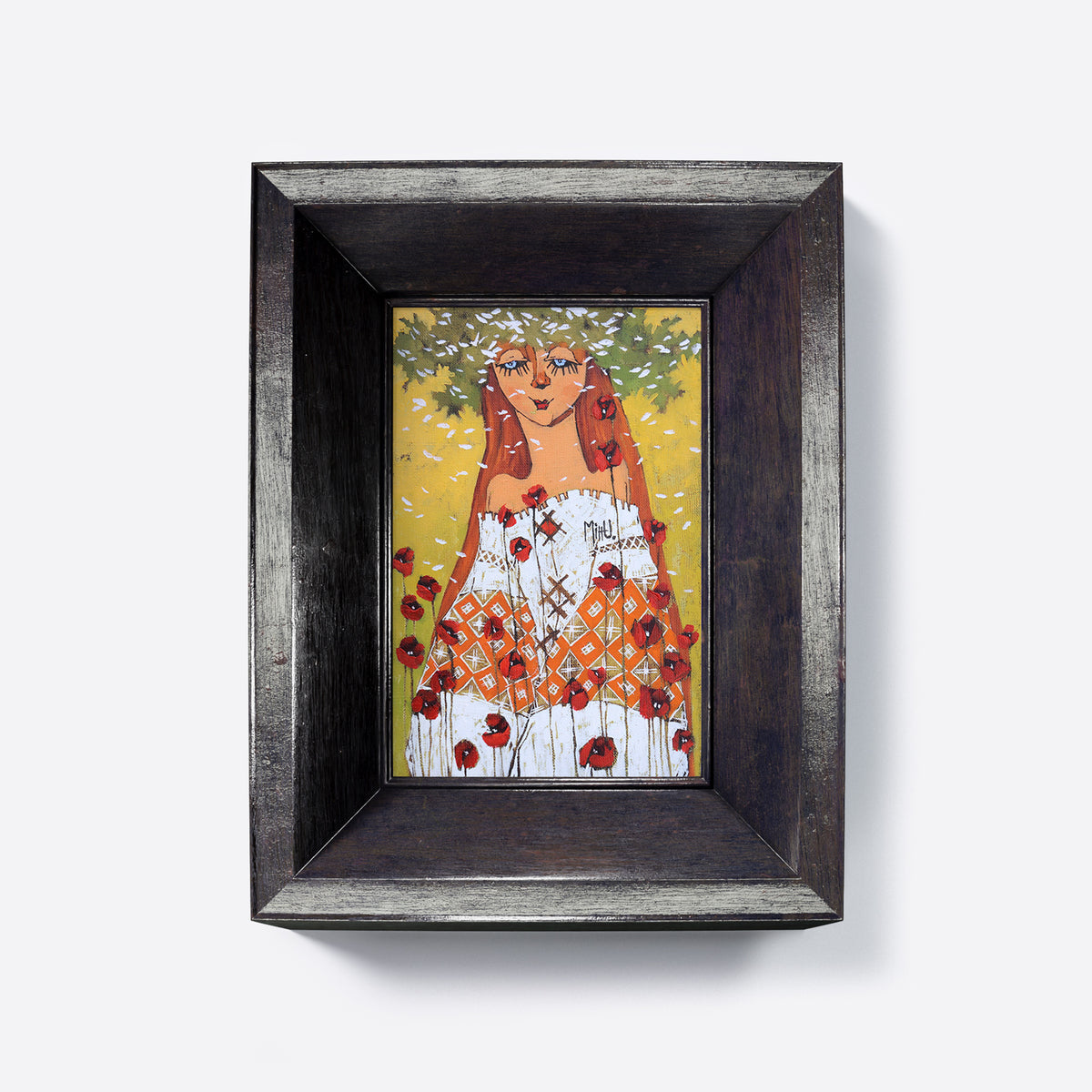 Framed artwork of a stylized woman with red hair and poppies, on a warm yellow background