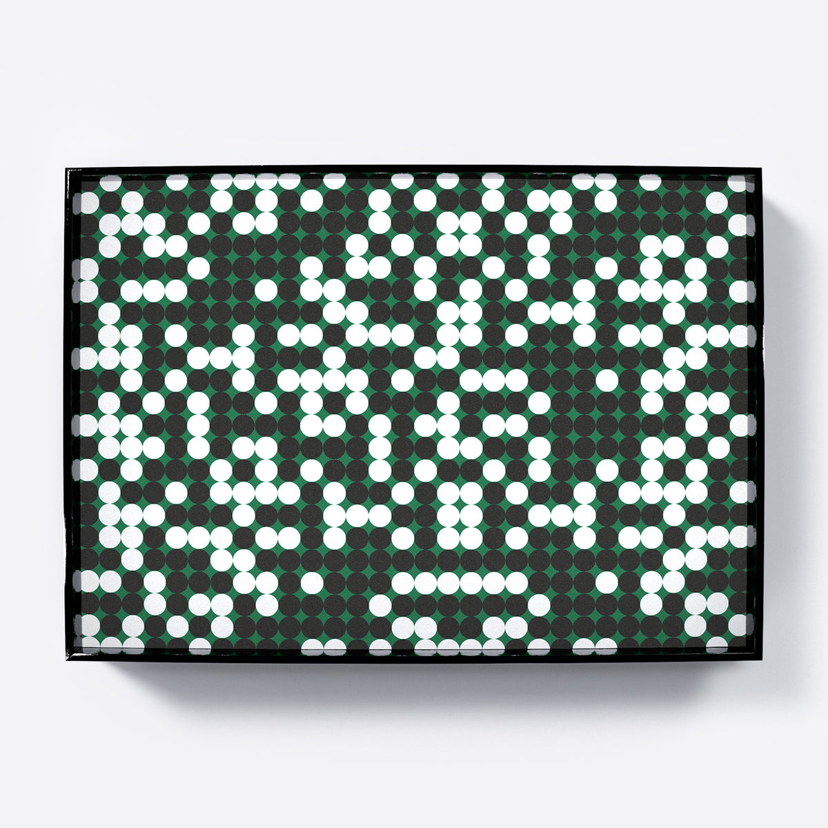 Patterned design art print with white and black dots on a green background.
