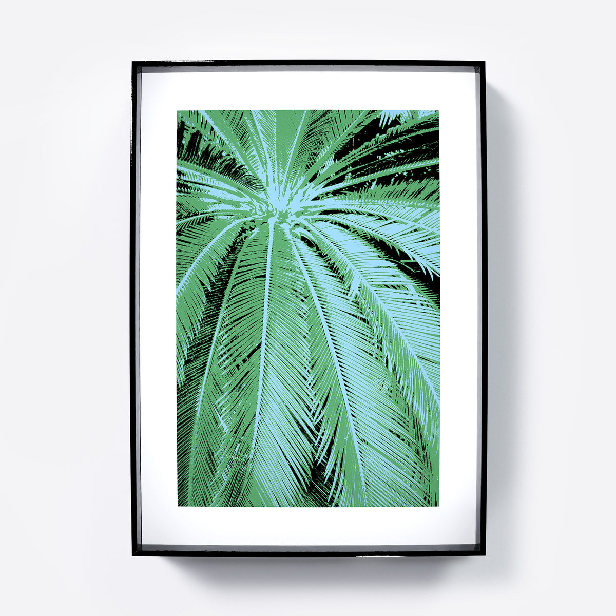 Framed artwork of a palm leaf design on a white background