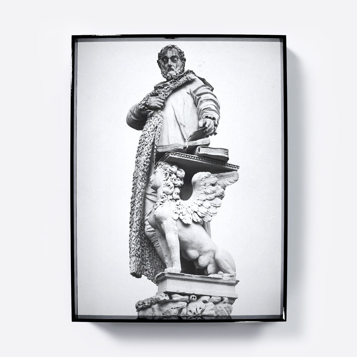 Framed black and white statue print on a white background