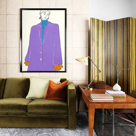 Framed fashion illustration print hanging on a wall of a chic apartment above a sofa.