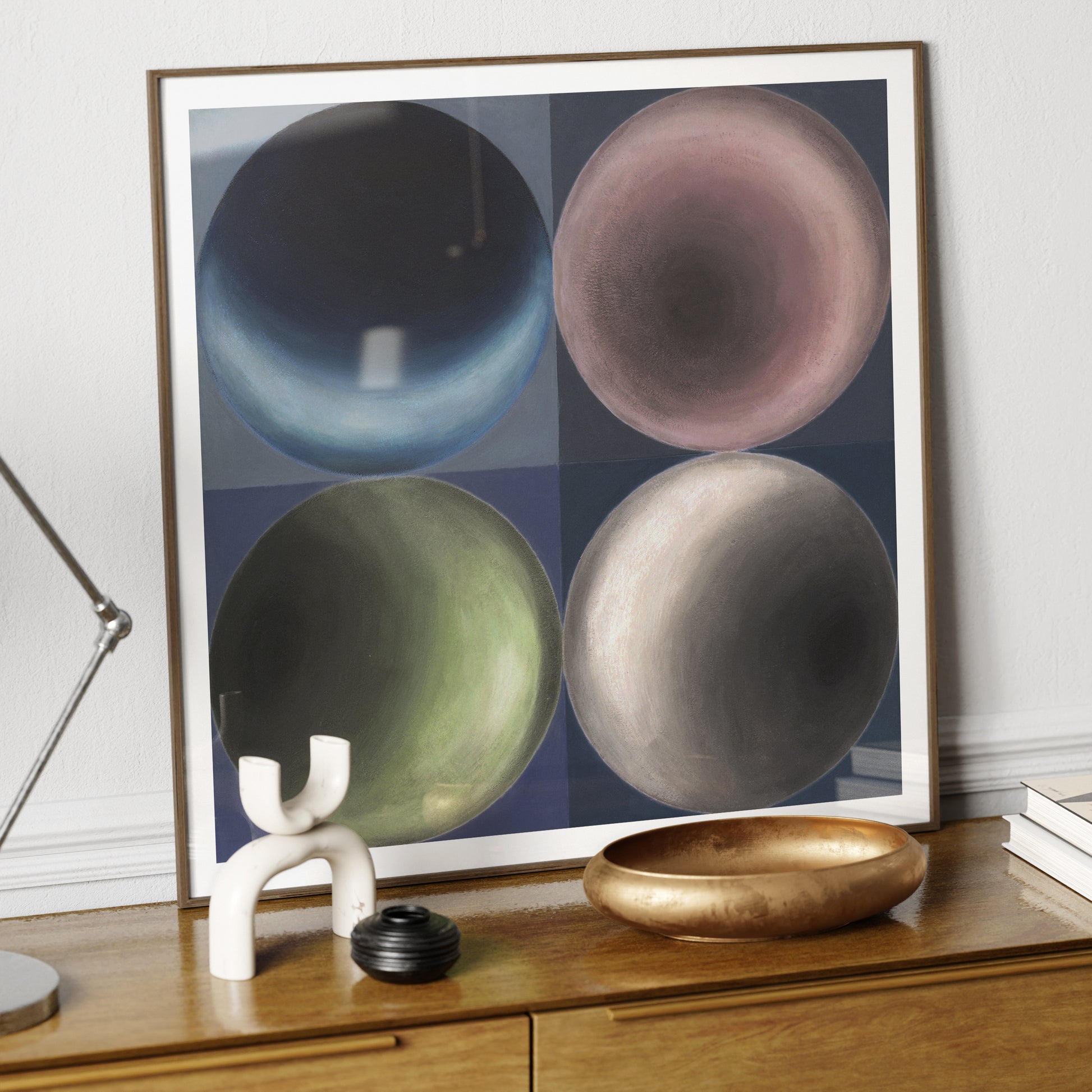 Geometric art print on a wood sideboard.