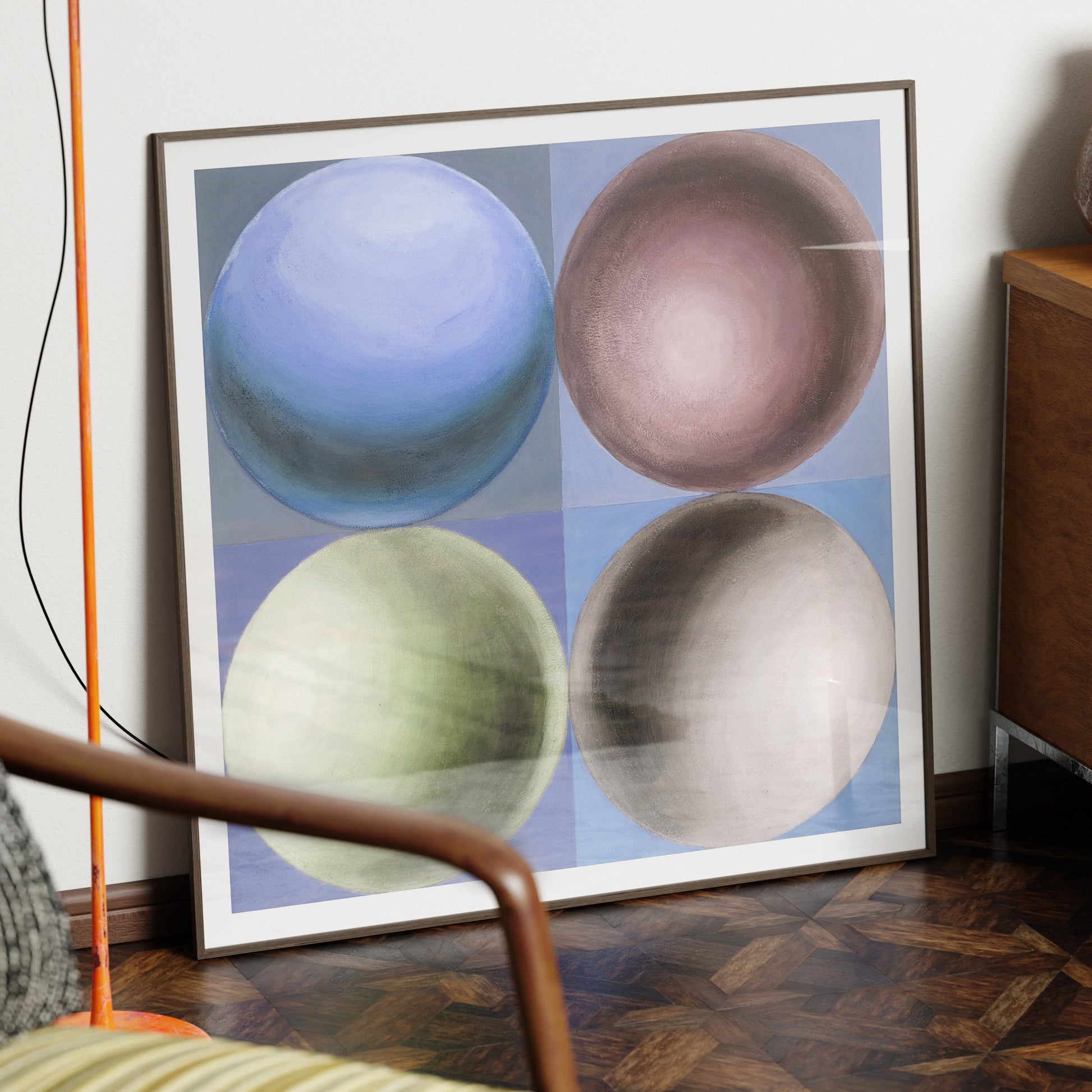 Geometric art print with spheres in a dark wood frame.