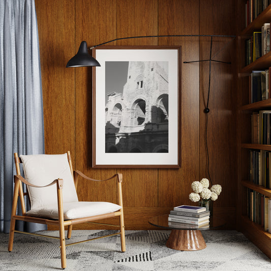 Black and white photography art print that depicts ancient architecture, on a wood panel wall. 