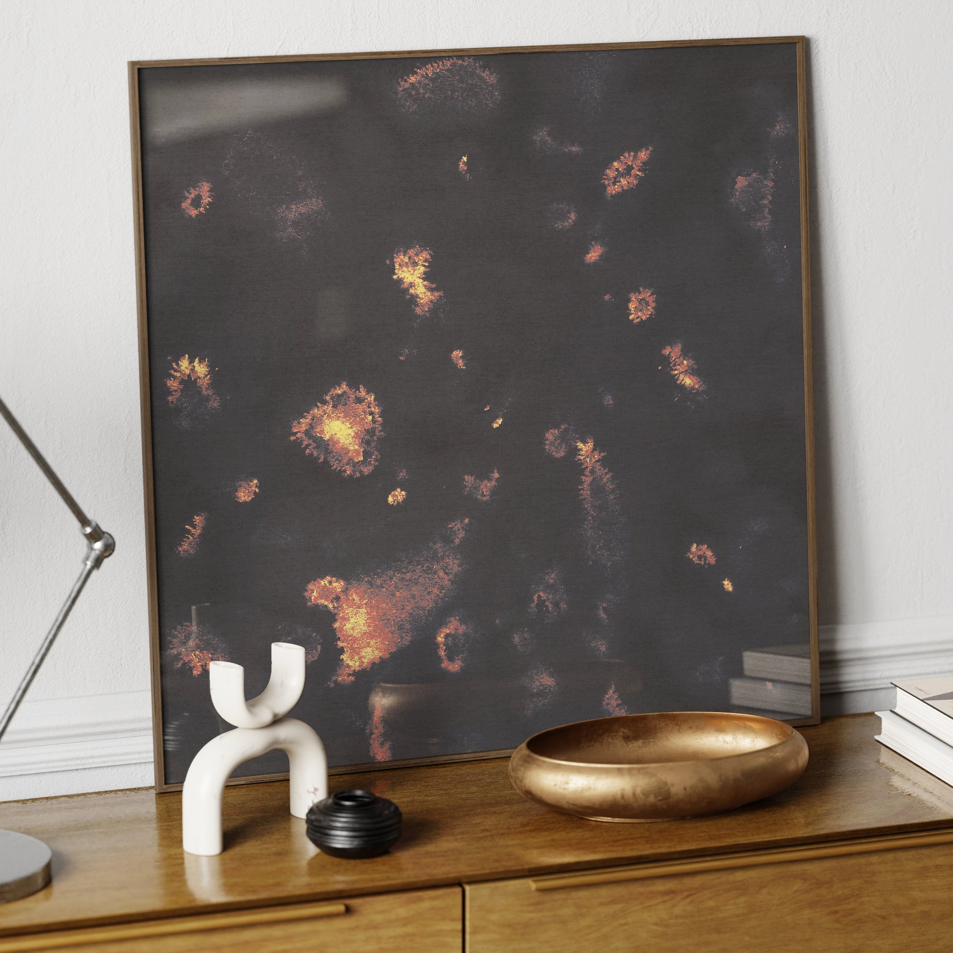 Dark abstract art print in watercolor technique, on an elegant sideboard.
