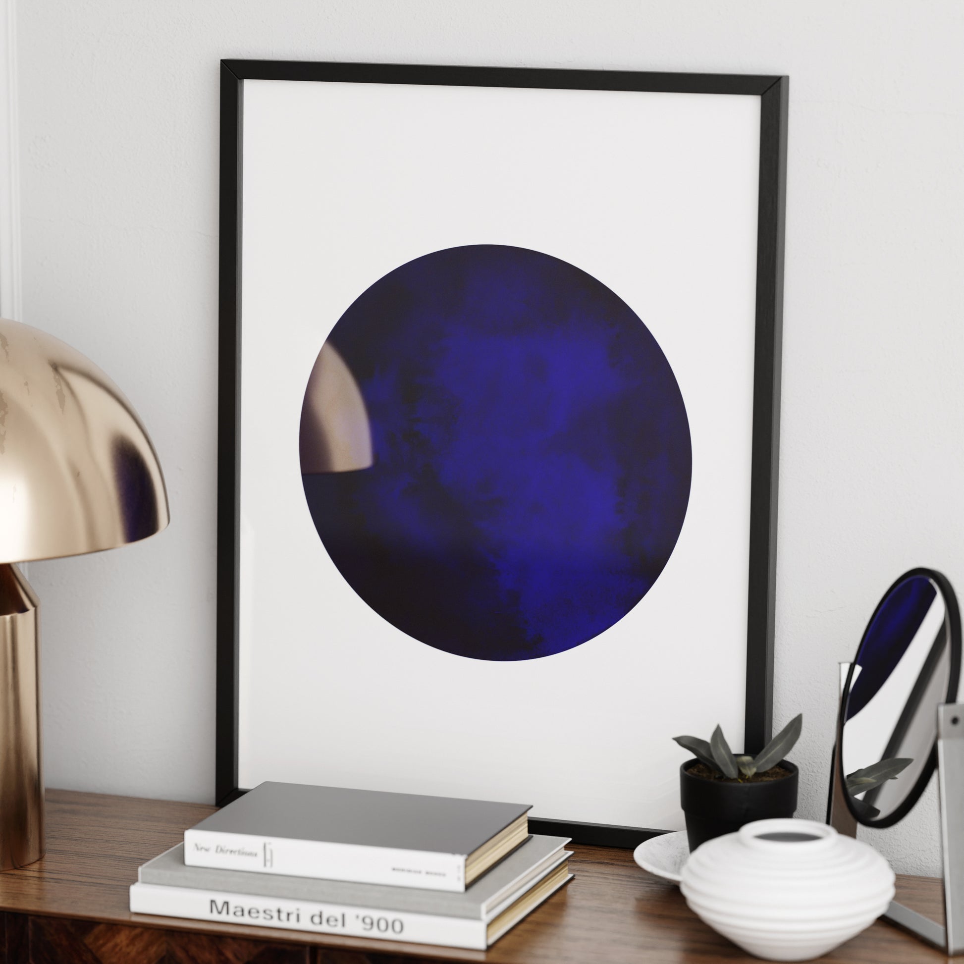 Blue planet minimalist graphic art print on a sideboard.