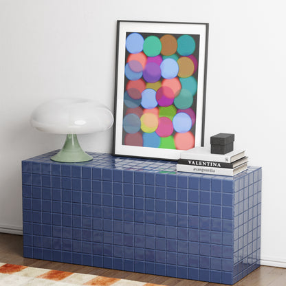 Blue tiled side table with a colorful abstract art print on a white wall.