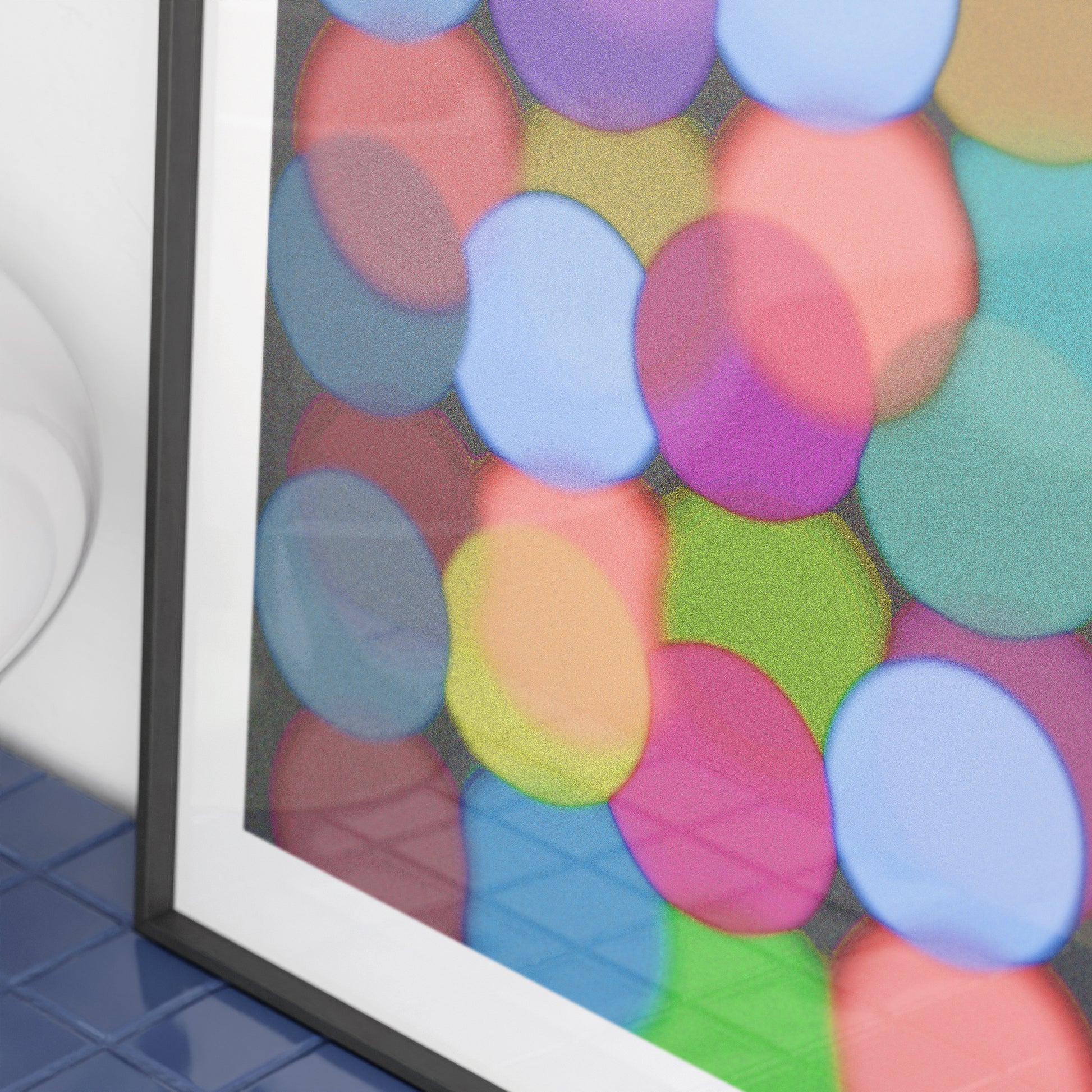 Framed artwork with colorful circular patterns on a black background.