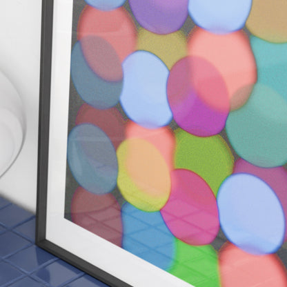 Framed artwork with colorful circular patterns on a black background.