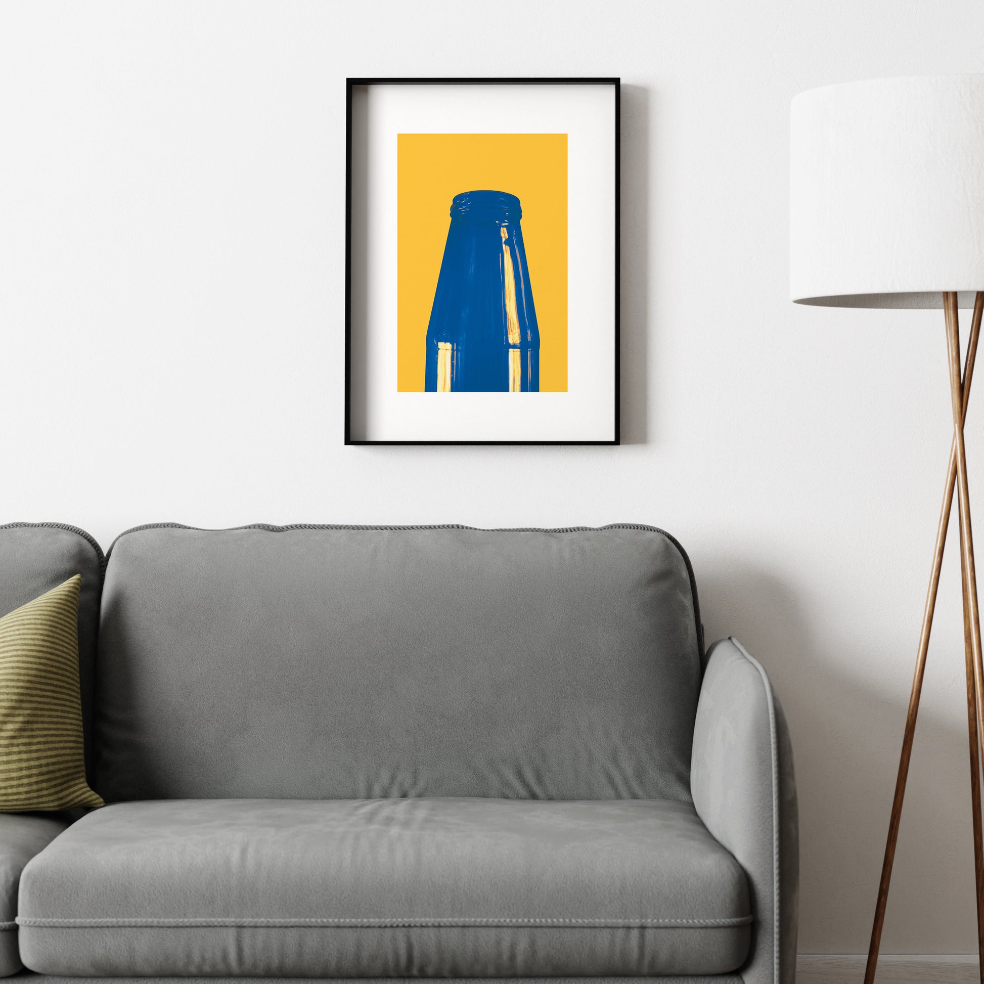 Minimalist graphic art print with blue and yellow above a sofa.