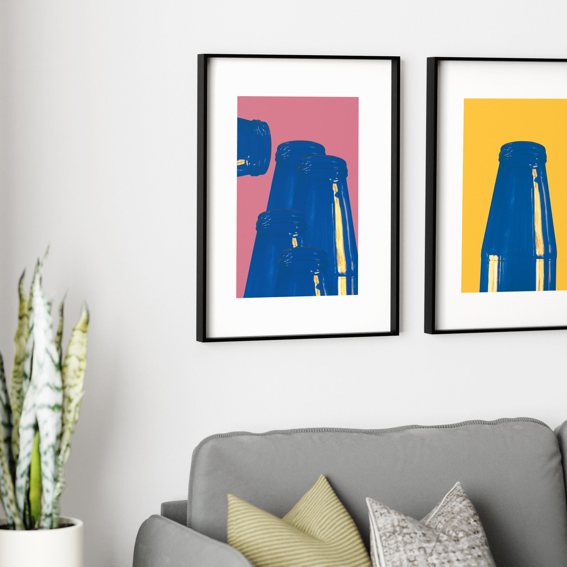 Group of two graphic art prints above a sofa.