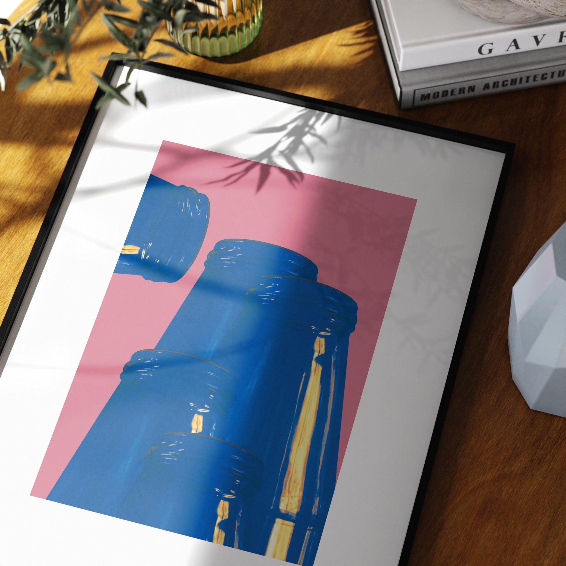 Pink and blue graphic art print in a moody space.