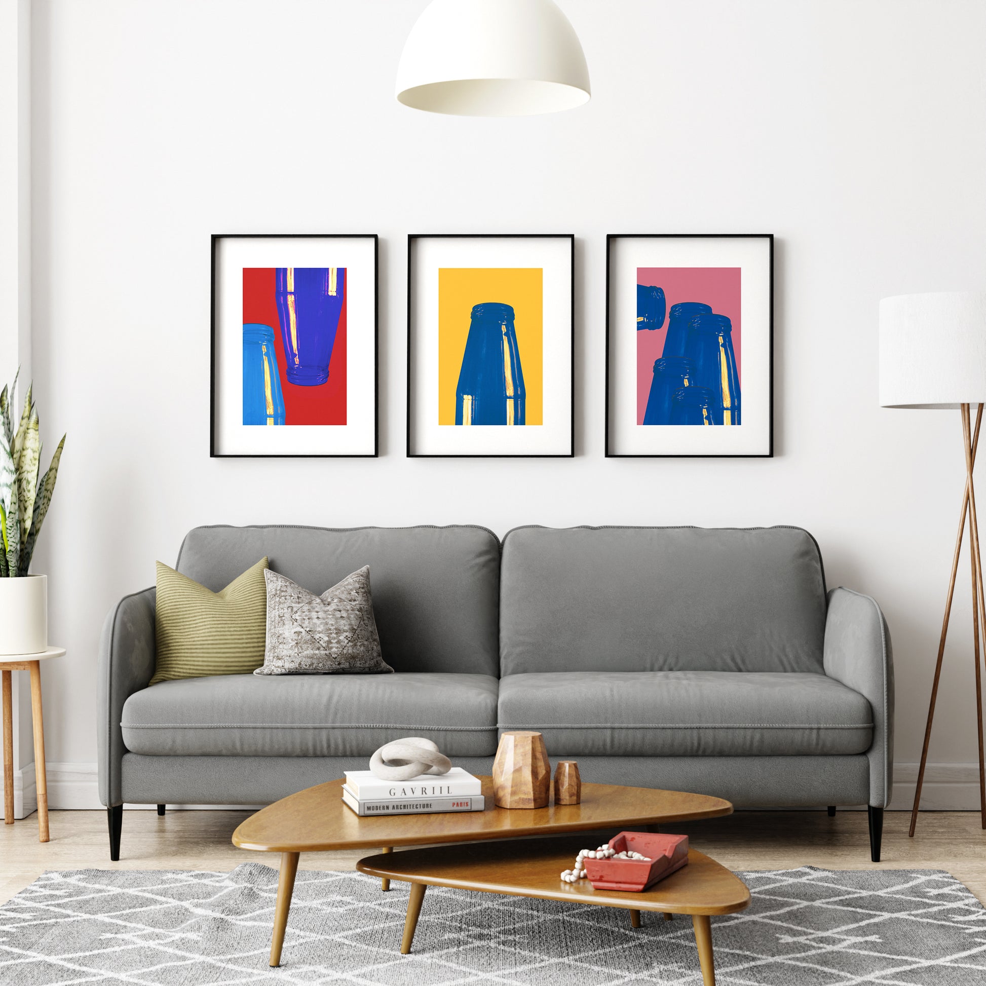 Group of three graphic art prints in a living room.