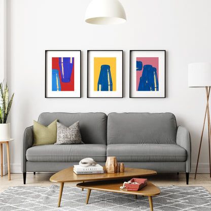 Group of three graphic art prints in a living room.