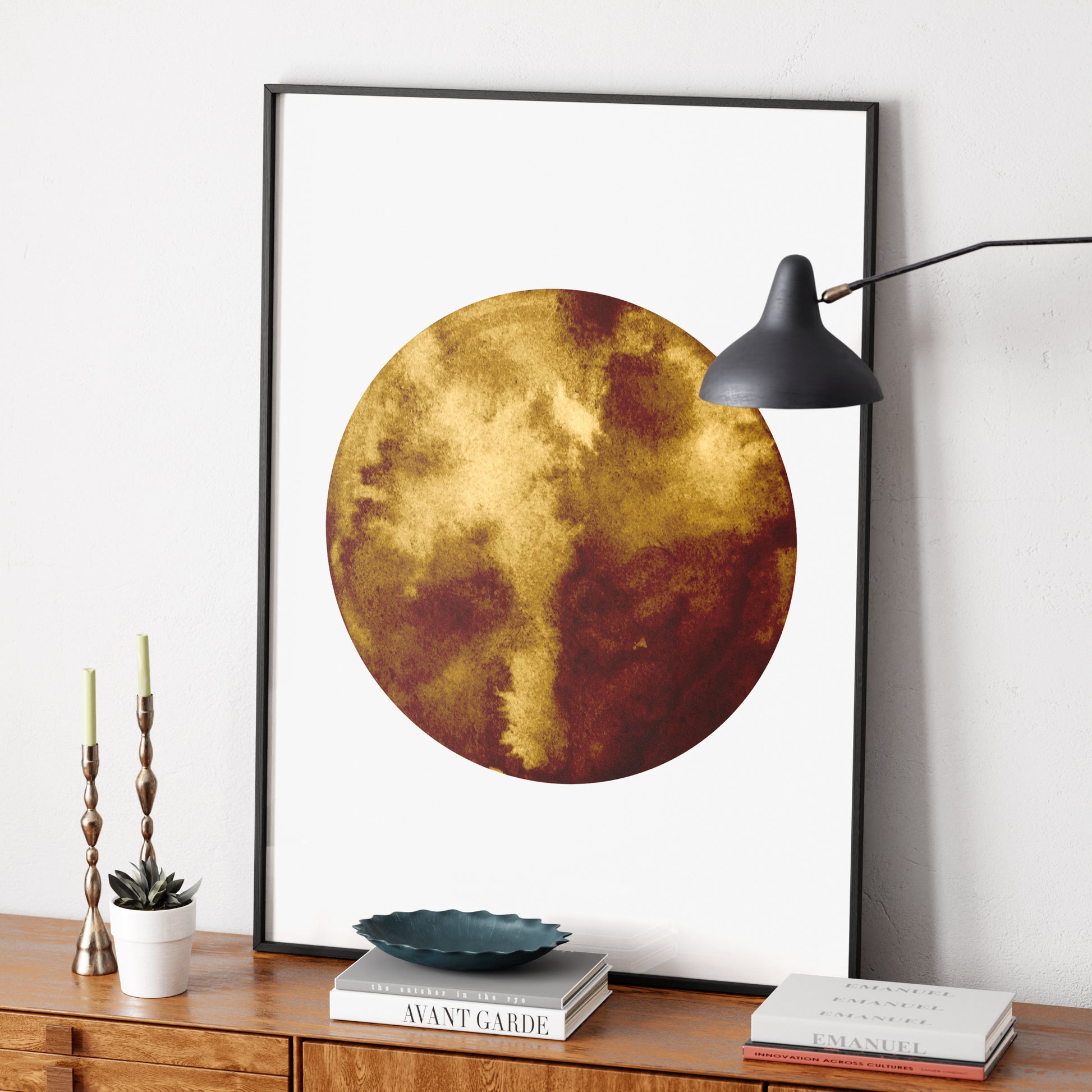 Planet minimalist graphic art print on a mid-century modern sideboard.