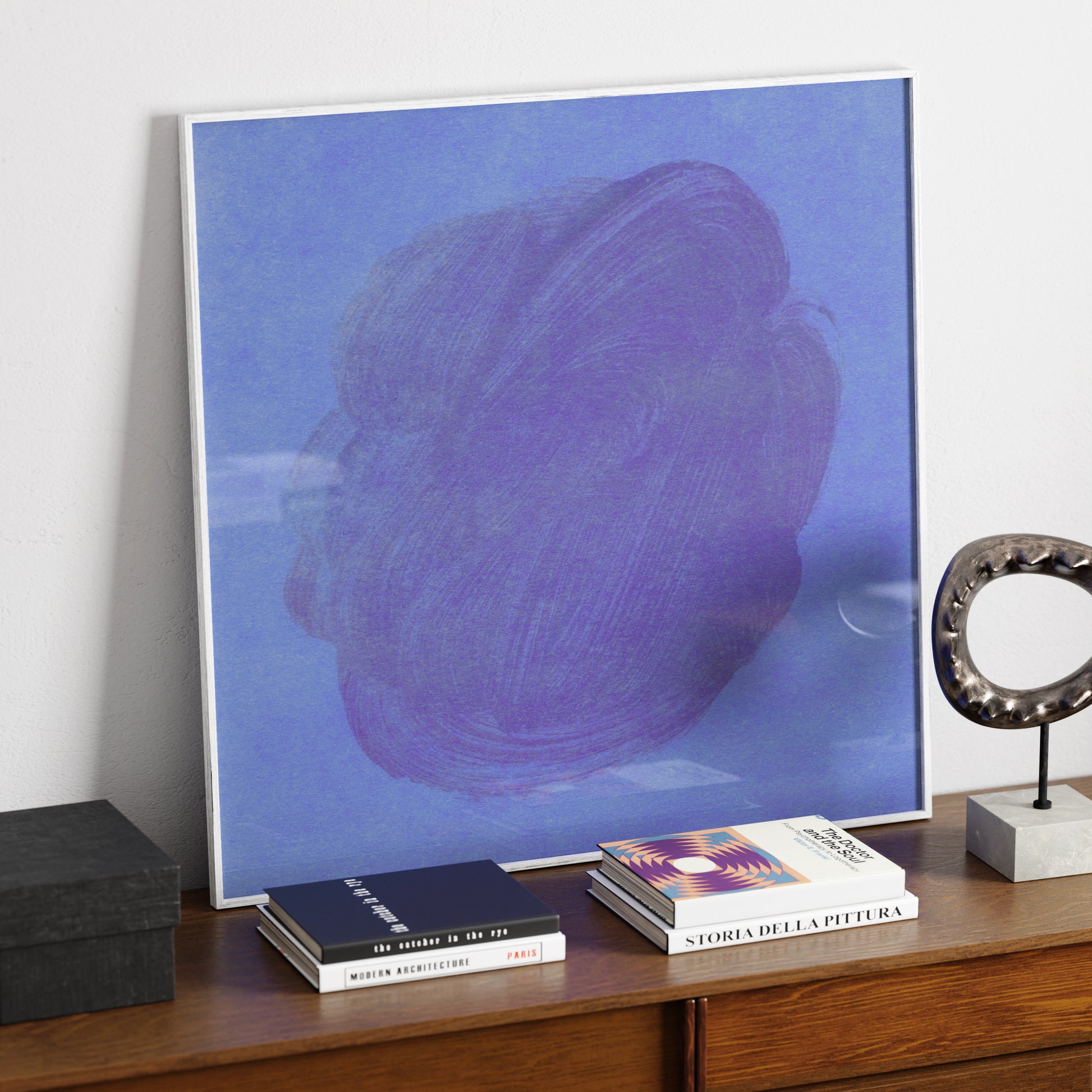 Blue abstract contemporary art print on a sideboard.