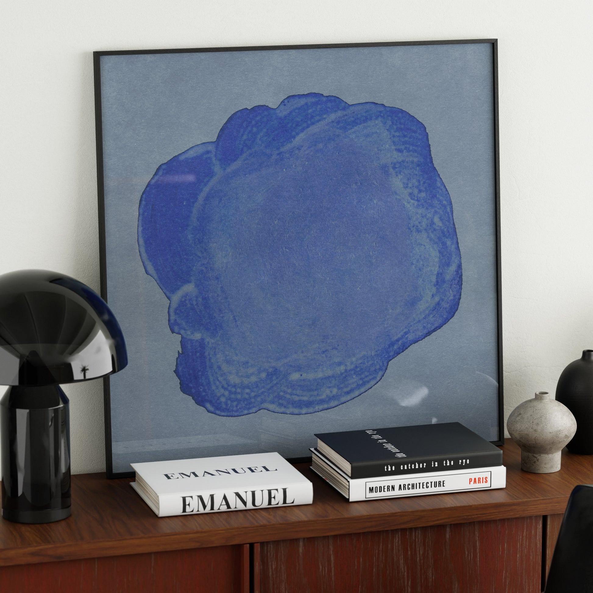 Blue minimalist abstract contemporary art print on a red sideboard.