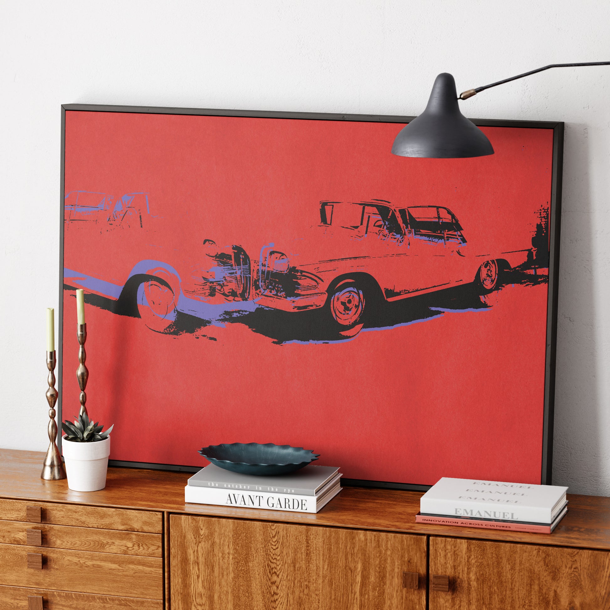 Red car crash pop art art print on a sideboard.