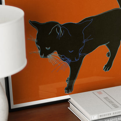 Detail of an art print that depicts a black cat on an orange background.