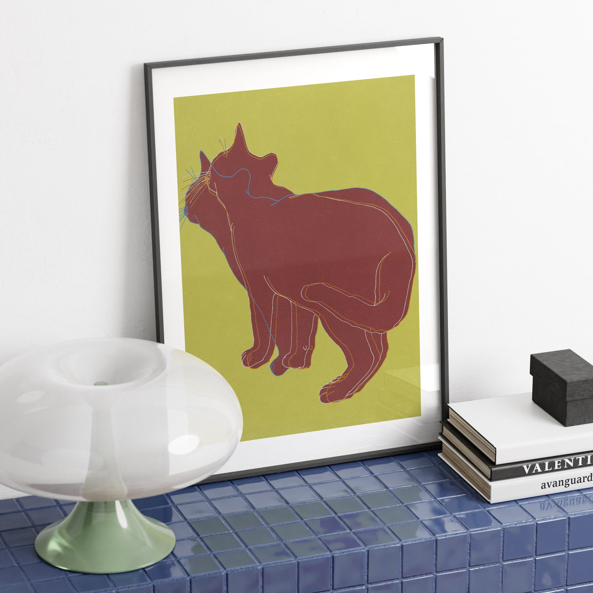 Art print with a cat on a sideboard with blue tiles.