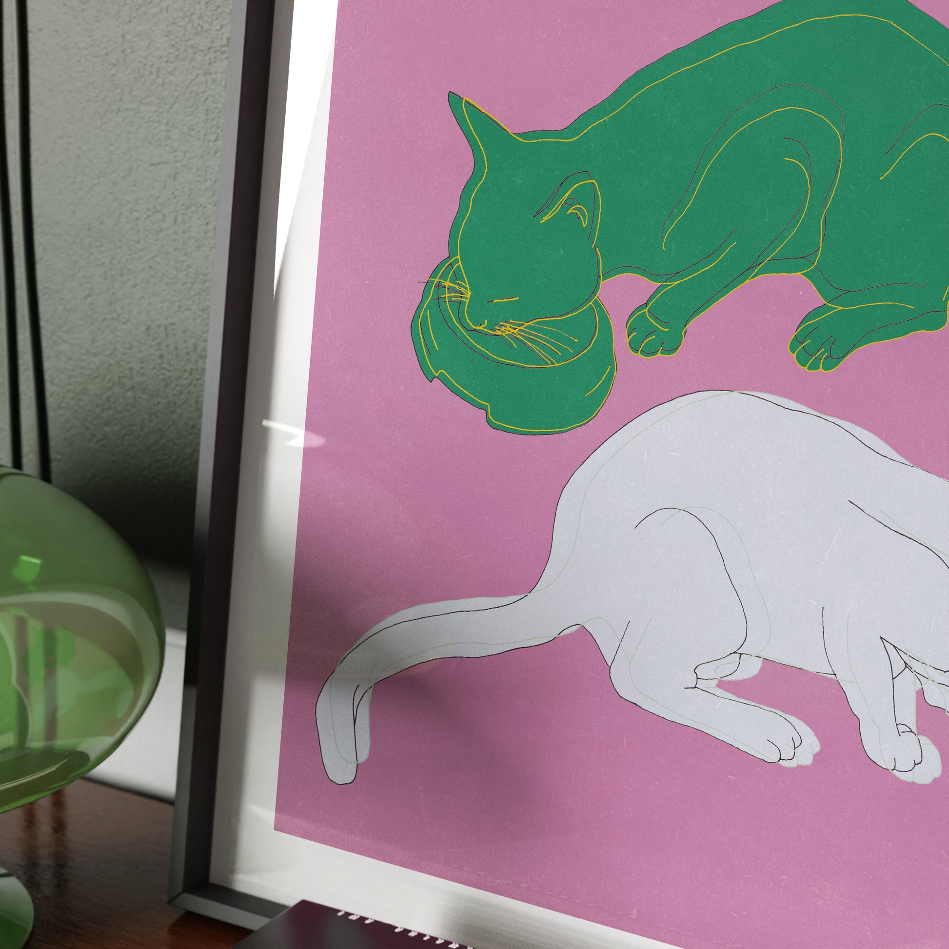 Detail of an art print depicting two cats on a pink background.